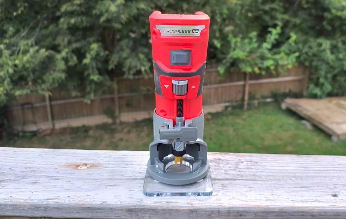A cordless router on a wooden rail