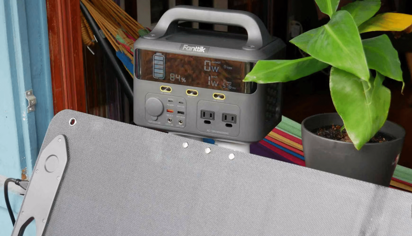Fanttik EVO 300 power station and solar panel on window sill close up